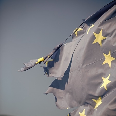 101185914-european-union-twelve-star-flag-torn-and-with-knots-in-wind-on-blue-sky-background-close-up-flag-is.jpg