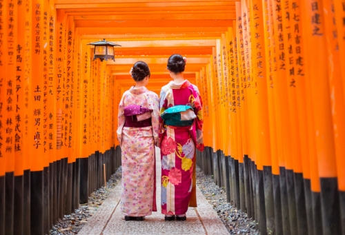 Two geishas among red wooden Tori Gate at Fushimi Inari Shrine © kasto - adobe_product_preview.jpeg