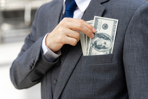 close-up-business-man-holding-money-us-dollar-bills-in-hand.jpg